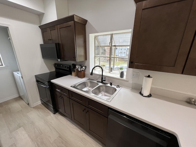 kitchen with black appliances, dark brown cabinetry, sink, and light hardwood / wood-style flooring