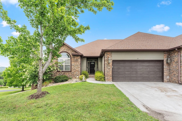 single story home with an attached garage, concrete driveway, roof with shingles, and a front yard