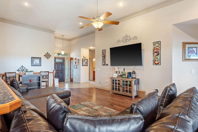 living room featuring crown molding, ceiling fan, and hardwood / wood-style flooring