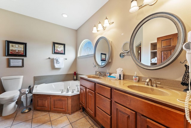 bathroom with a tub, tile patterned flooring, vanity, and toilet