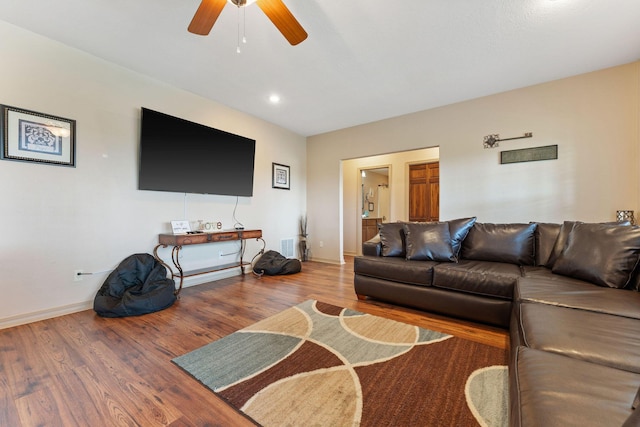 living room featuring hardwood / wood-style flooring and ceiling fan