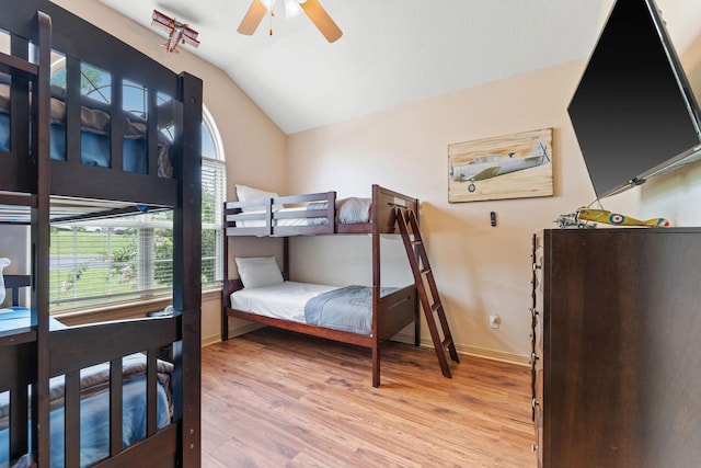 bedroom featuring ceiling fan, lofted ceiling, and light wood-type flooring