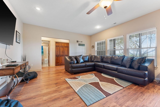 living room featuring ceiling fan and light hardwood / wood-style floors