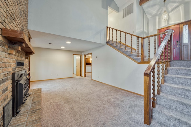 unfurnished living room with carpet floors and a towering ceiling