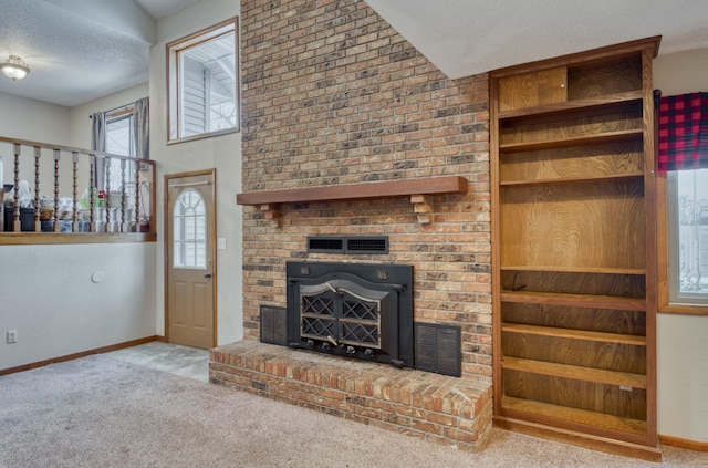 unfurnished living room featuring light carpet, a textured ceiling, and a brick fireplace