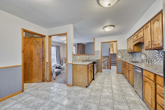 kitchen featuring sink, light tile patterned flooring, backsplash, and stainless steel appliances