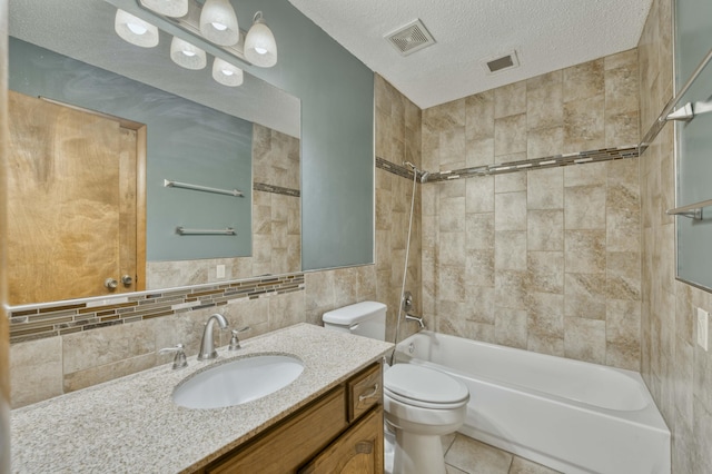 full bathroom with toilet, a textured ceiling, tiled shower / bath combo, tile walls, and vanity