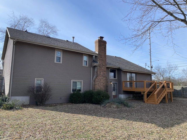 rear view of house with a deck and a lawn