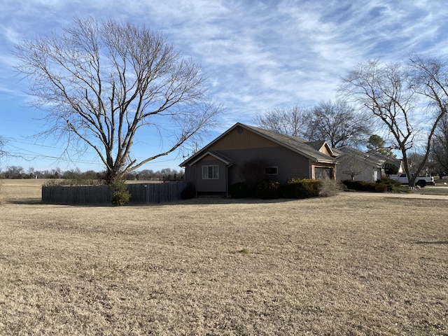 view of side of property with a lawn