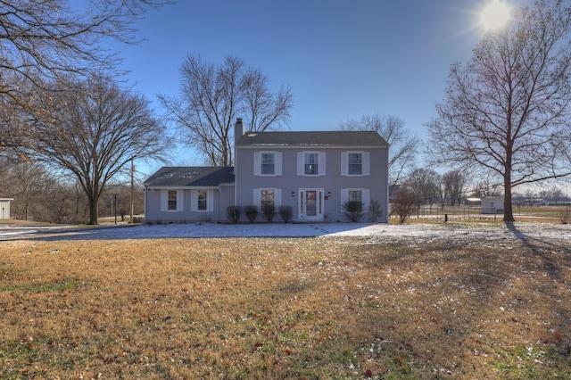 colonial home with a front yard