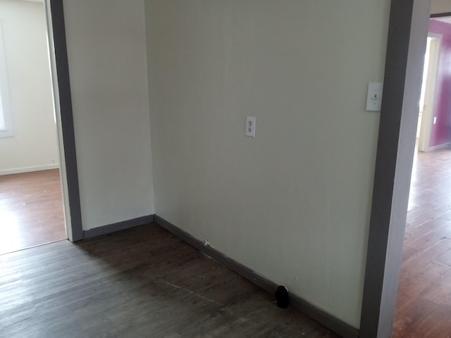 unfurnished room featuring dark wood finished floors and baseboards