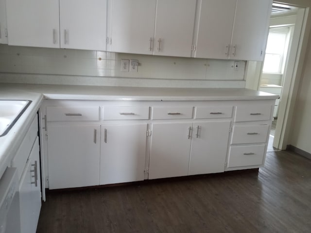 kitchen with dark wood-style floors, light countertops, decorative backsplash, and white cabinets