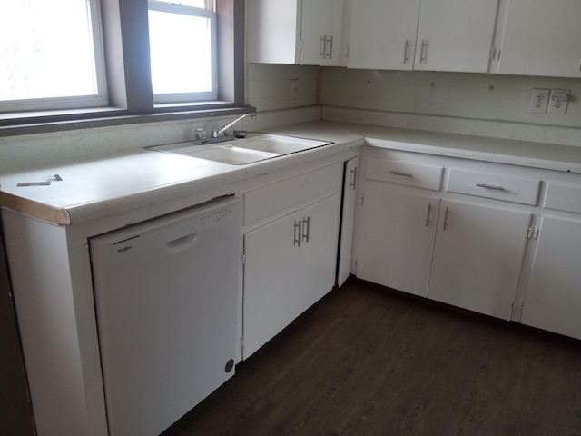 kitchen featuring light countertops, white cabinets, and white dishwasher