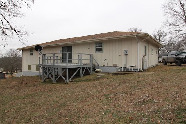 back of house with a deck