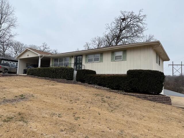 single story home featuring a carport