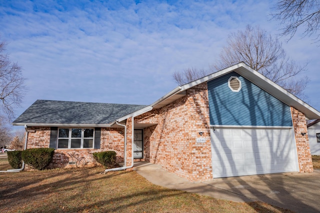 view of front of home with a garage and a front lawn