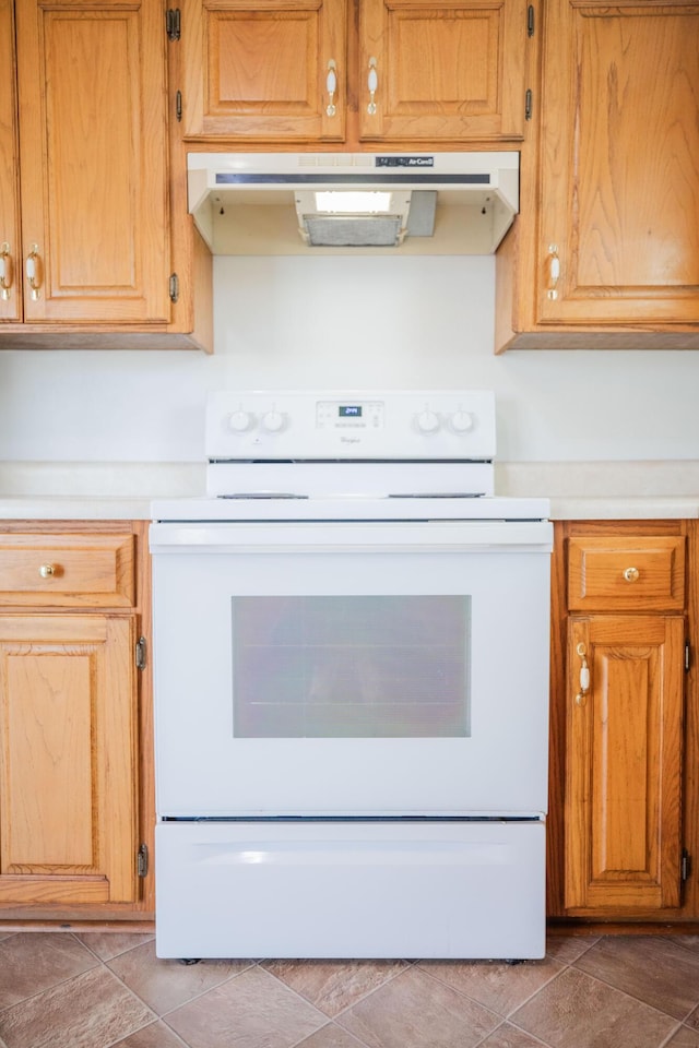 kitchen featuring tile patterned floors and white electric stove