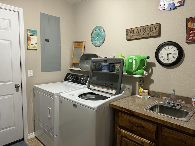 laundry area with electric panel, separate washer and dryer, and sink