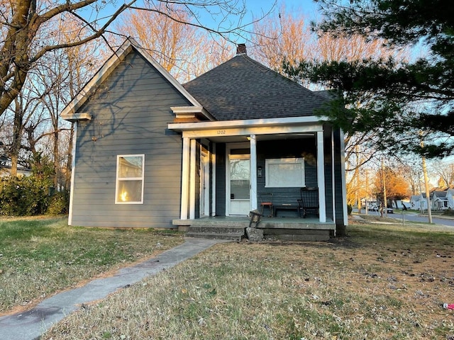 view of front of house with a porch and a front yard