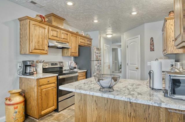 kitchen featuring light stone countertops, a textured ceiling, and appliances with stainless steel finishes