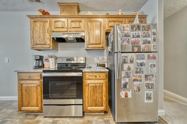 kitchen featuring appliances with stainless steel finishes and a textured ceiling