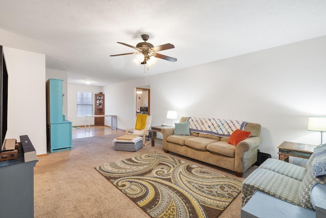 living room featuring carpet floors and a ceiling fan