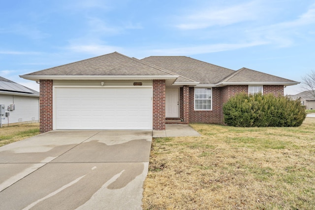 ranch-style home featuring a garage and a front lawn