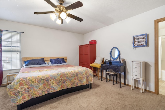 bedroom with a ceiling fan, carpet flooring, and baseboards