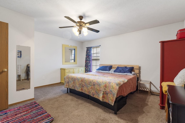 carpeted bedroom with ceiling fan, a textured ceiling, and baseboards