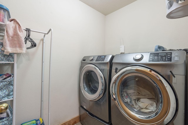 clothes washing area featuring laundry area and separate washer and dryer