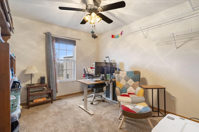 home office with light carpet, baseboards, and a ceiling fan