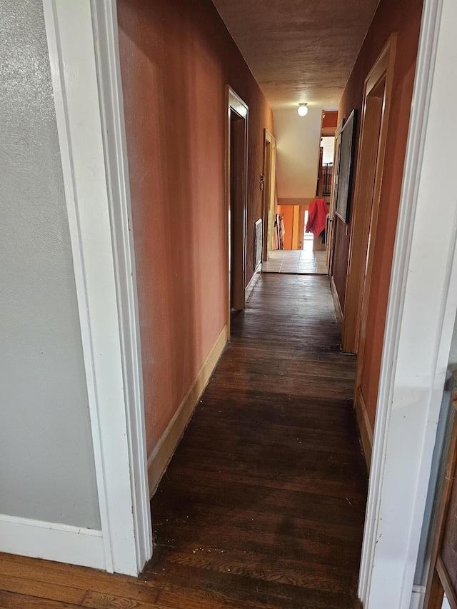 corridor featuring dark hardwood / wood-style flooring