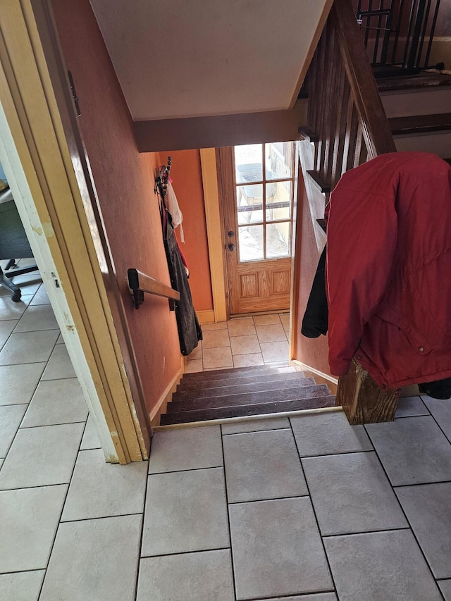 entryway with light tile patterned flooring