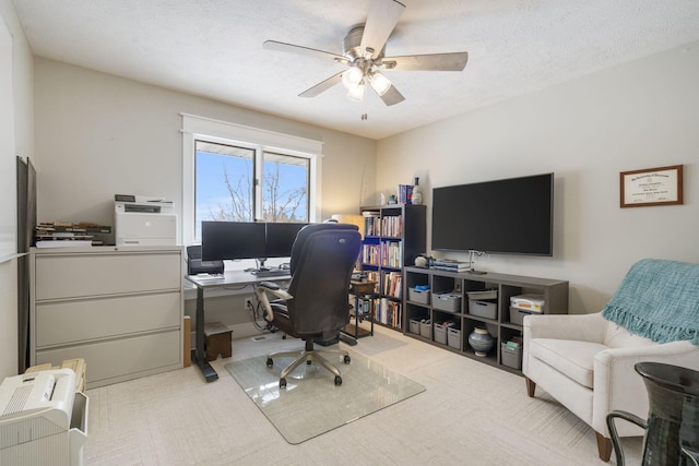 office with carpet, ceiling fan, and a textured ceiling