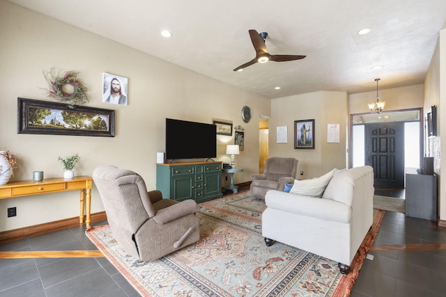 living room with ceiling fan with notable chandelier, dark tile patterned flooring, baseboards, and recessed lighting