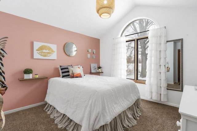 carpeted bedroom featuring lofted ceiling and baseboards