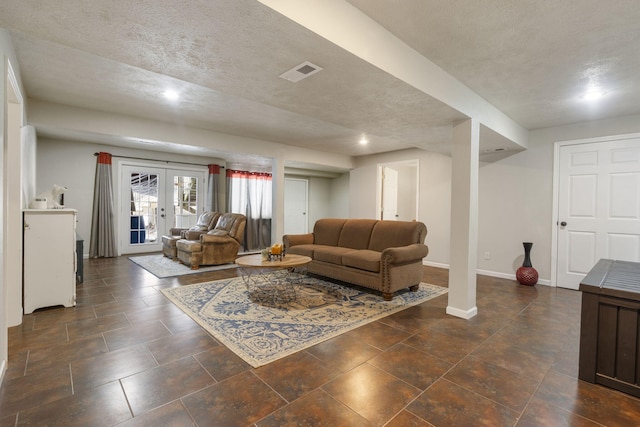 living room featuring french doors, visible vents, a textured ceiling, and baseboards