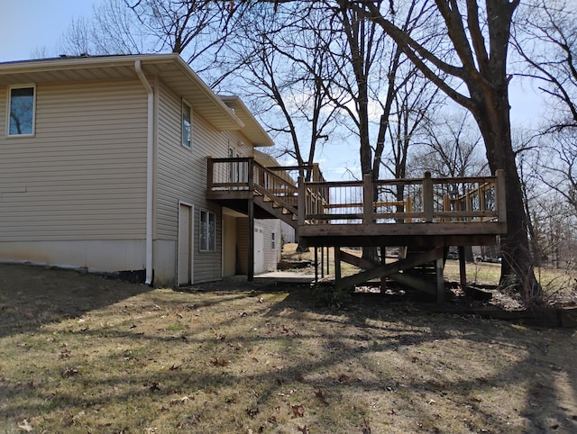 view of side of home featuring stairway and a wooden deck