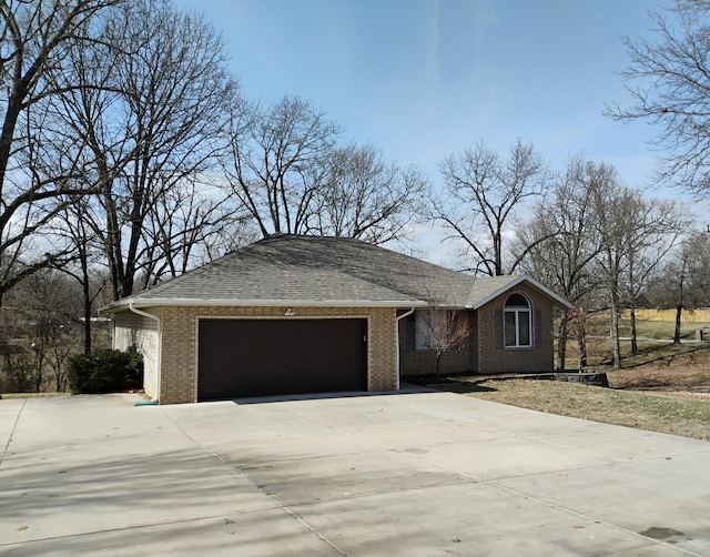 view of front of house with brick siding, driveway, and an attached garage