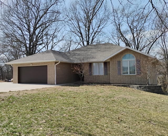 ranch-style home with an attached garage, a front lawn, and brick siding