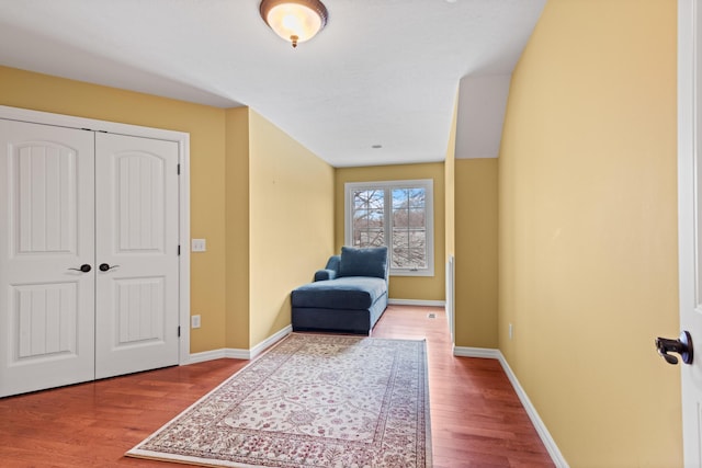 living area with baseboards and wood finished floors