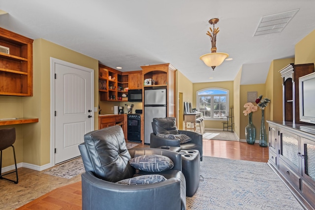 living room with baseboards and visible vents