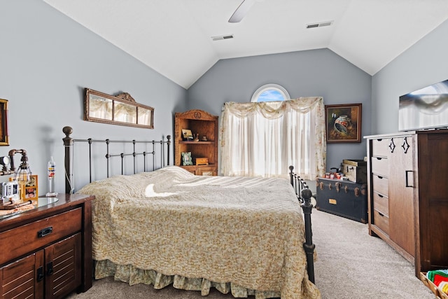 bedroom featuring visible vents, lofted ceiling, ceiling fan, and light colored carpet