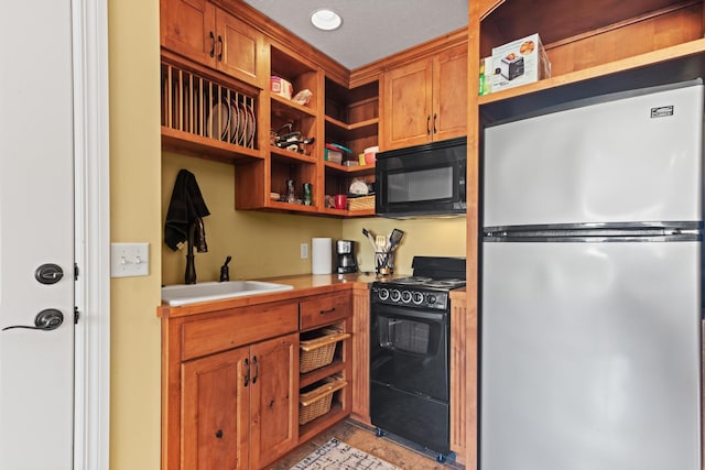 kitchen featuring open shelves, brown cabinets, black appliances, and light countertops