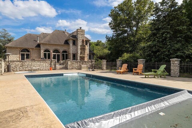 view of pool with a fenced in pool, fence, and a patio