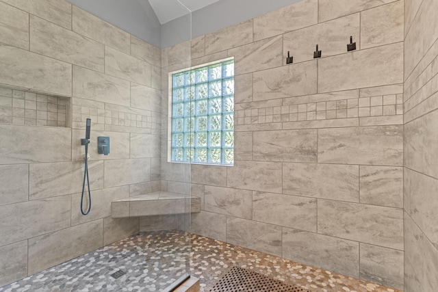 bathroom featuring a healthy amount of sunlight and tiled shower
