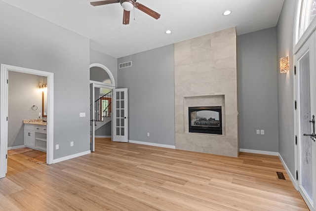 unfurnished living room with visible vents, a ceiling fan, and light wood finished floors