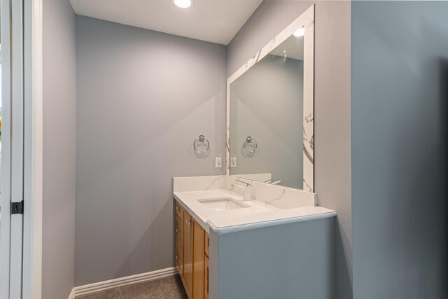 bathroom with vanity, recessed lighting, and baseboards