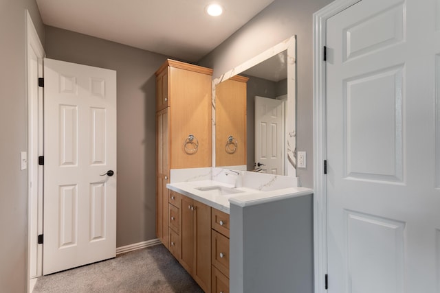 bathroom featuring baseboards and vanity