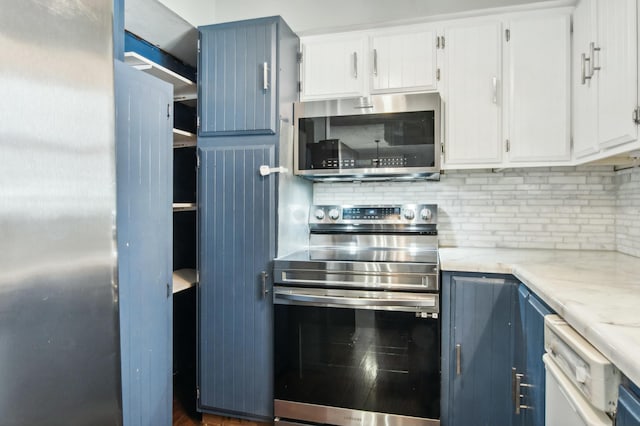 kitchen with backsplash, blue cabinets, white cabinets, and appliances with stainless steel finishes